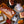 Load image into Gallery viewer, Assorted raw meats including ribs, steaks, and ground beef on a wooden cutting board with fall leaves.