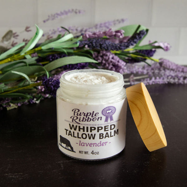 Purple Ribbon Whipped Tallow Balm jar with lavender flowers in the background