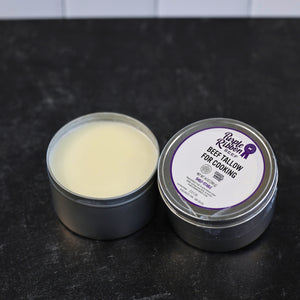 Purple Ribbon Beef cooking tallow in an open tin beside its labeled 14 oz container